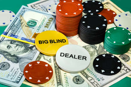 American money dollars and poker chips on casino table close up.