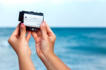ODESSA, UKRAINE, SEPTEMBER, 2017: Female hands shooting video with Sony Action Cam X3000 on a...
