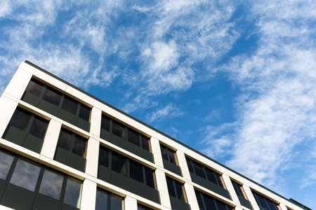 Exterior of new  apartment buildings on a blue cloudy sky background. No people.  Real estate business concept.の写真素材