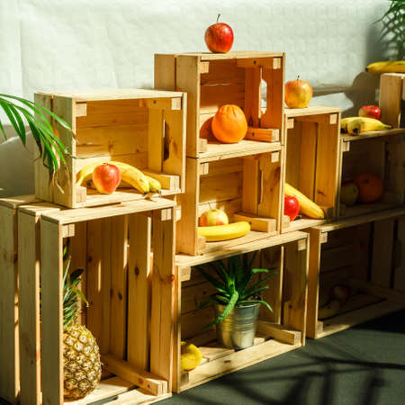 Bananas, oranges, apples in wooden boxes. Selling fresh fruit in the market