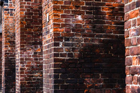 Dark brick wall of an old Catholic cathedral. Low key background.の写真素材