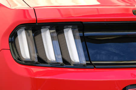 Backlights of vintage retro red racing car ckose-up.