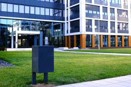 Coutyard of a contemporary business district wita a garbage bin.