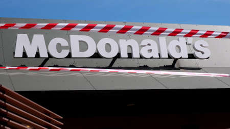 KRYVYI RIH, UKRAINE - APRIL, 2020. McDonald's fast food restaurant building surrounded by red and...