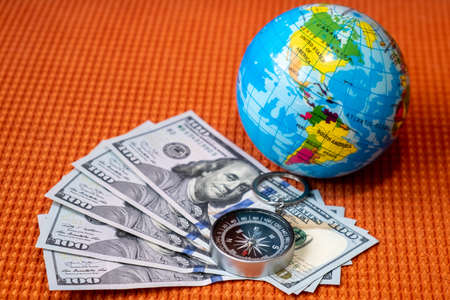 Five Hundred Dollars USA, Compass, Globe of Planet Earth on a Fabric Texture  Background Closeup....