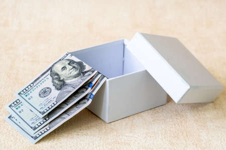 3 American Dollar Bank notes of 100 Dollars in white gift box. Studio Shot.の写真素材