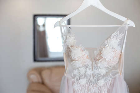 Luxury Lace Wedding Dress Hanging in a room.の写真素材