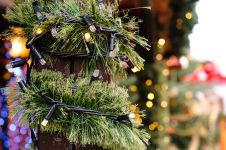 Christmas Decorated City Fair of Lighting LED Garland and Artificial New Year Tree branch at Winter day Outdoor, No Snow.の写真素材