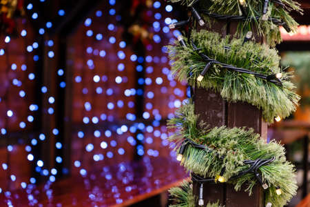 Christmas Decorated City Fair of Lighting LED Garland and Artificial New Year Tree branch at Winter...