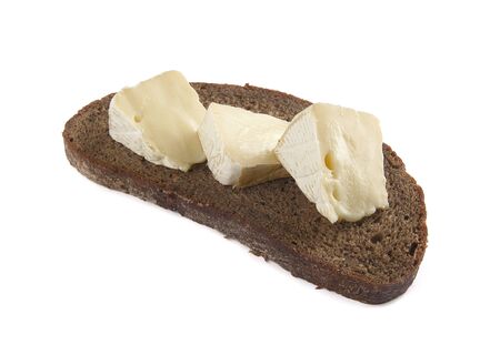 Pieces of camambert on the black bread;の写真素材