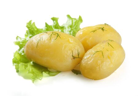 Three boiled potatoes on the fresh green lettuceの写真素材