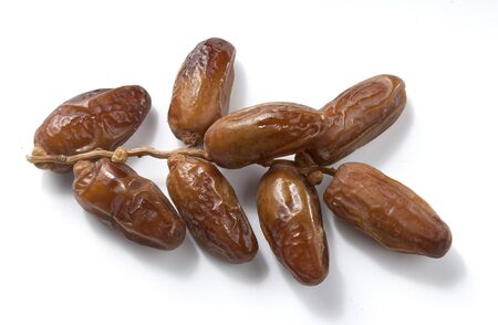One isolated branch of dates on the white background