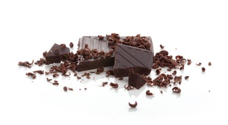 Pieces of chocolate bar with crumbs and cjips on the white backgroundの写真素材