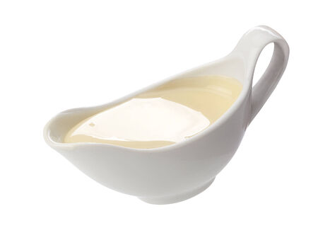 White isolated sauceboat with condensed milk on the whiteの写真素材