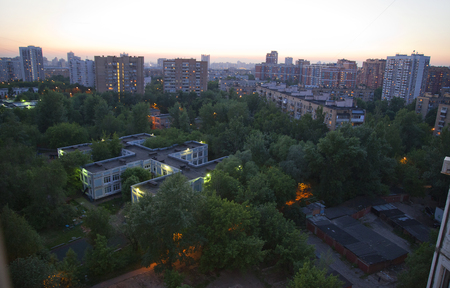 Moscow residental building and green trees in the eveningの写真素材