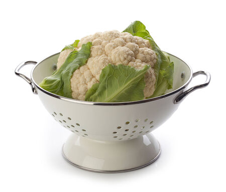 Head of cauliflower in the white metal colanderの写真素材