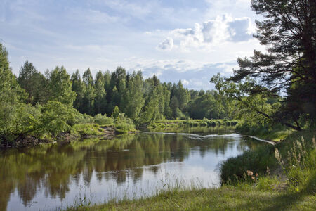 Summer landscape with river, forest and cloudsの写真素材