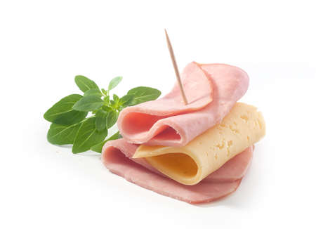 Folded cheese and ham with fresh green basil on the whiteの写真素材