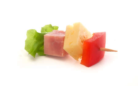 Isolated canape with ham, cheese and red pepper on the toothpickの写真素材