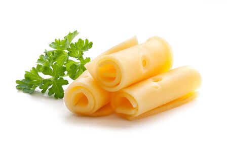 Three roll of cheese with fresh green parsley on the whiteの写真素材