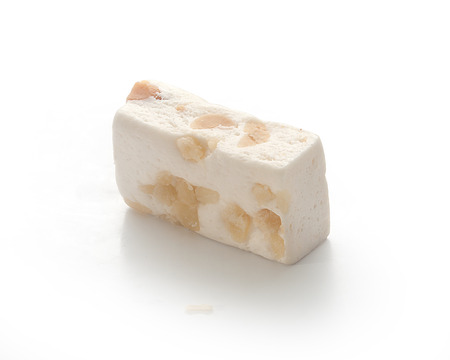 Candy nougat with peanut and dried fruit on the white backgroundの写真素材