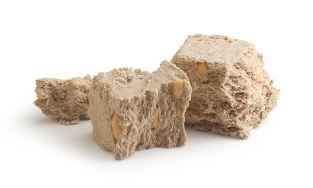 Some pieces of halva with peanut on the white background