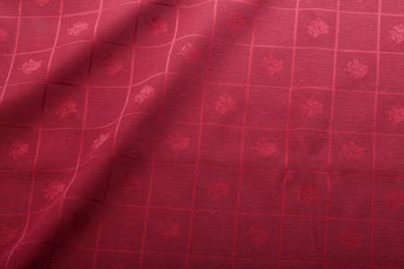 Folded red tablecloth with a cells decoration