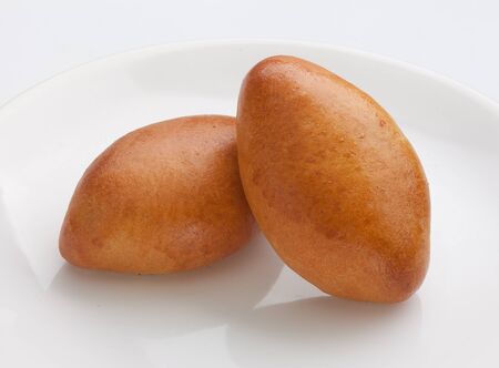 Isolated two ruddy pies on the white plateの写真素材