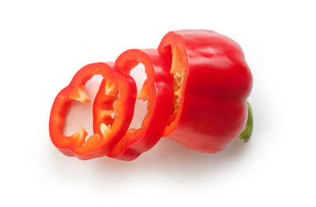 Top view of half and slices of red paprika on the whiteの写真素材