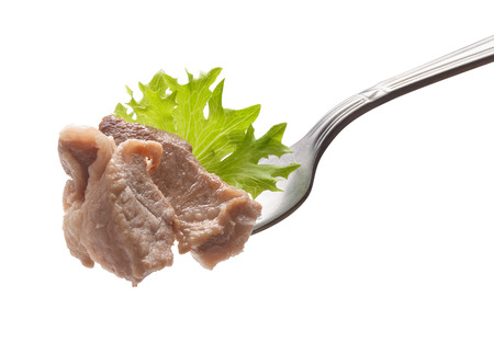 Pieces of roasted pork on the metal forkの写真素材