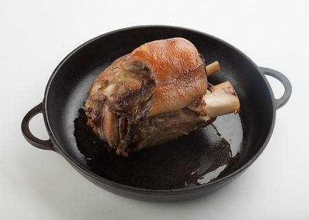 Roasted pork knuckle on the cast iron frying panの写真素材