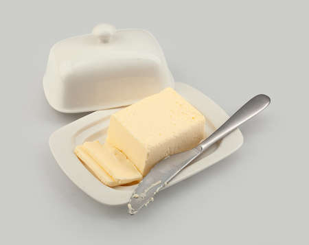 Isolated butter dish with butter and table knifeの写真素材