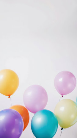 Aesthetic pastel colored balloons floating in the air against white wall background, copy space. Generative AI.の素材