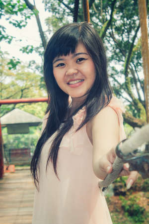 Beautiful young asian girl model standing at the bridgeの写真素材