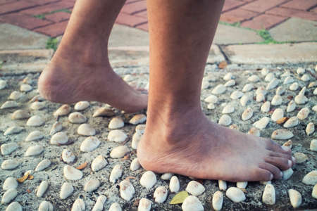 barefoot at cement stone track for massage the soles of the feet outdoorの写真素材