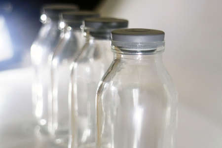 four neatly lined bottles close upの写真素材