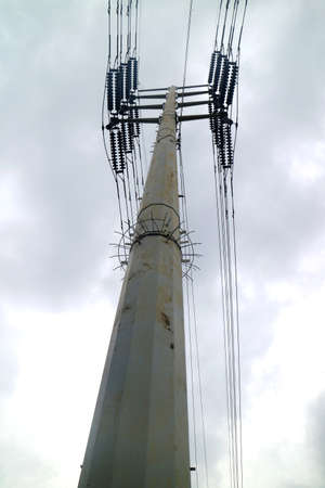 electric tower with multiple wires cloudy skyの写真素材