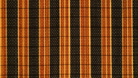 woven texture of dark brown and black combined sticks with a vertical arrangement studio photo