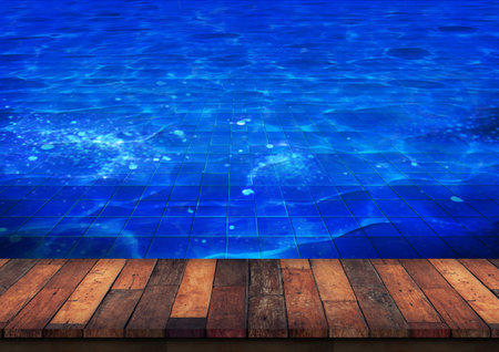 Wooden Deck Beside a Blue Tiled Swimming Pool