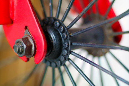 Close-Up of Red Bicycle Wheel Hub and Spokesの写真素材