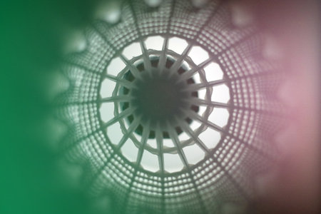 Close-Up Abstract View of White Plastic Shuttlecock with Soft Green Lighting