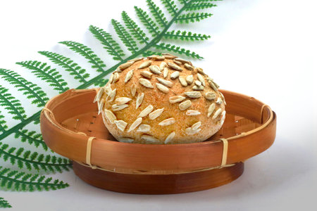 Fresh Baked Round Bread with Sunflower Seeds Topping in a Bamboo Basket