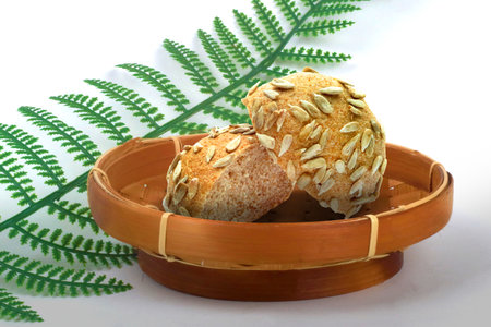 Fresh Baked Sweet Round Bread Slice with Sunflower Seeds Topping in a Bamboo Basket