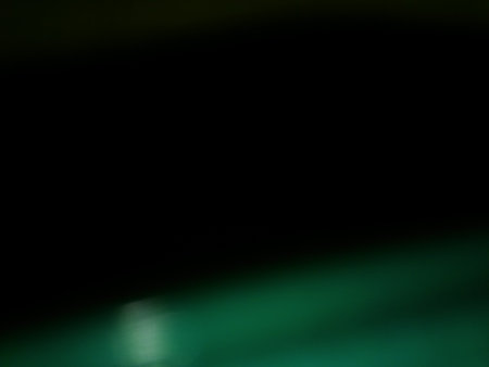 Conceptual dark green shiny blur background with shiny particles and different elements in close upの写真素材