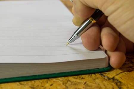 The human hand with a pen.の写真素材