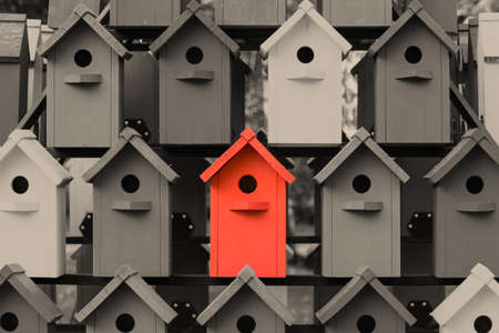 Red birdhouse stands out against black and whiteの写真素材