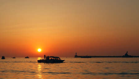 Sunset at sea in the summer. Several boats in the sea.の写真素材