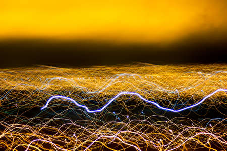 Blurred Light painting, Abstract of lighting equipment. Abstract yellow neon painting. Bokeh glitter round shapes. Abstract lights at motionの写真素材