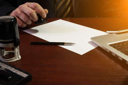 The businessman puts a stamp on the contract