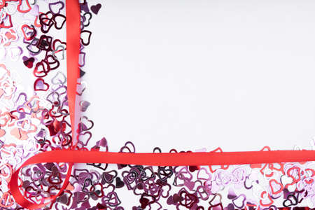 Many red heart shape red ribbon bow on white background, frame and space for text